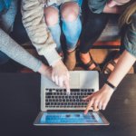 Students pointing at a laptop